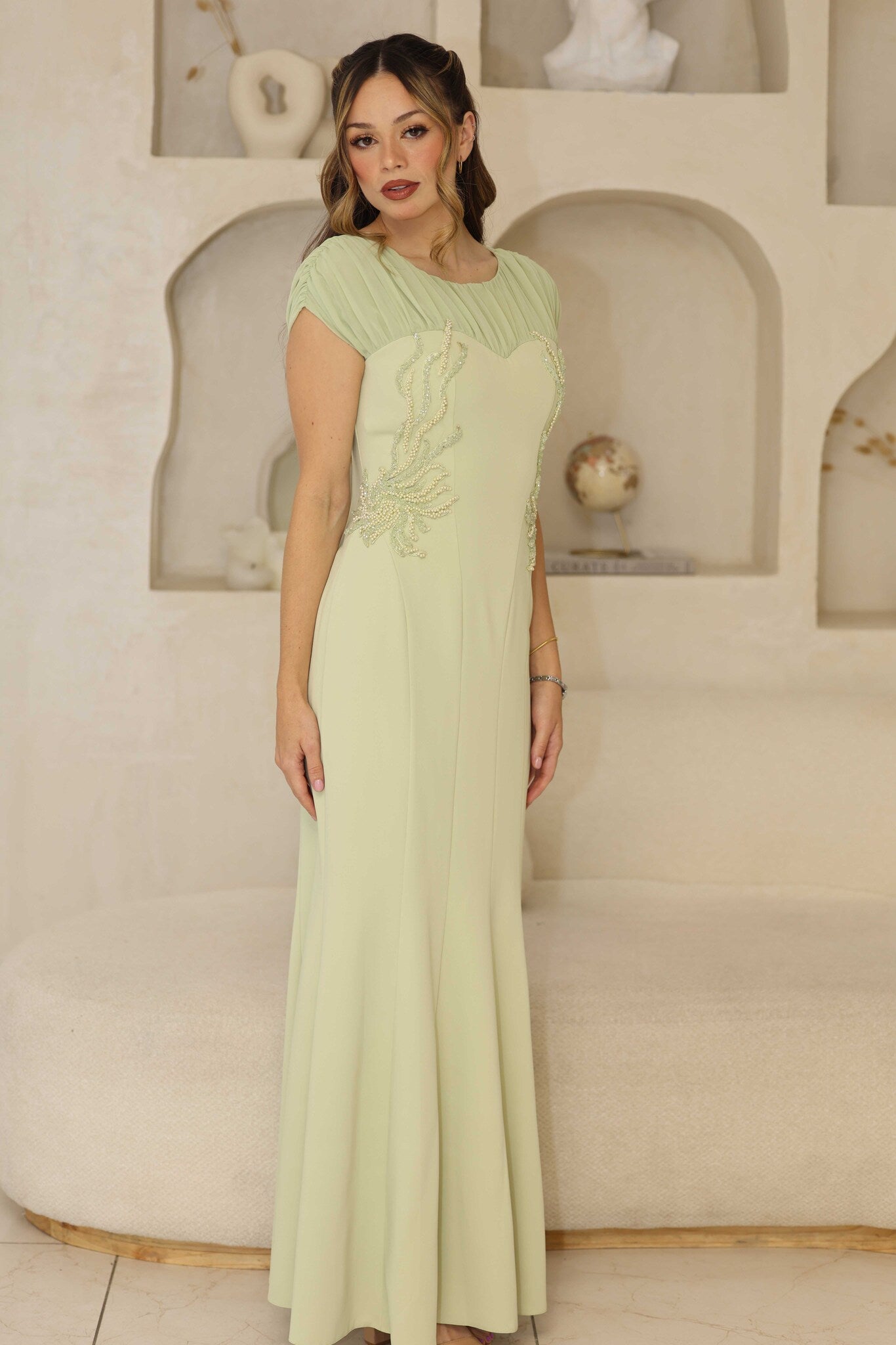 Pistachio fitted dress with pleated chiffon sleeves and beaded bodice.