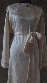 Exclusive Cream Silk satin dress with Beading on neckline and sleeve.
