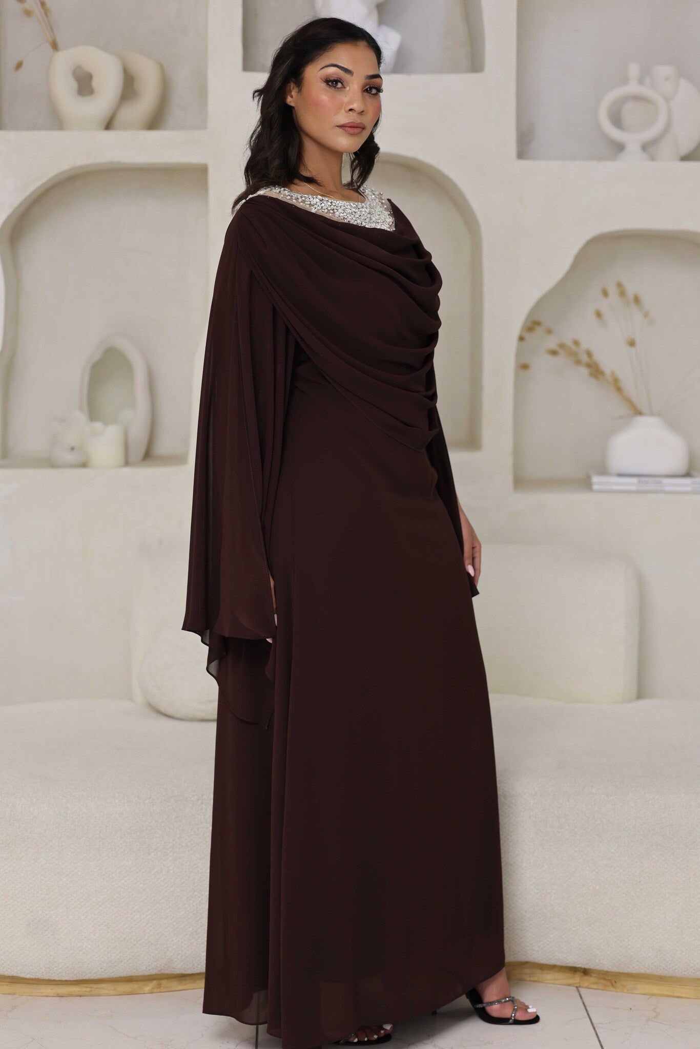 Full-length chocolate brown dress with rhinestone detailing on the neckline.
