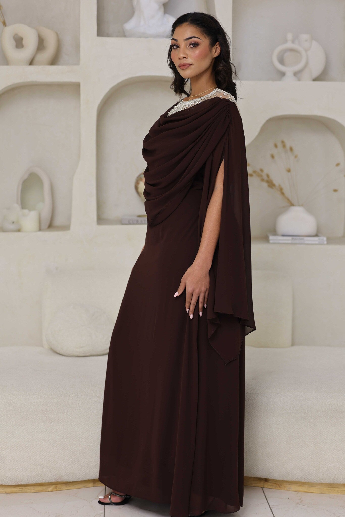 Full-length chocolate brown dress with rhinestone detailing on the neckline.