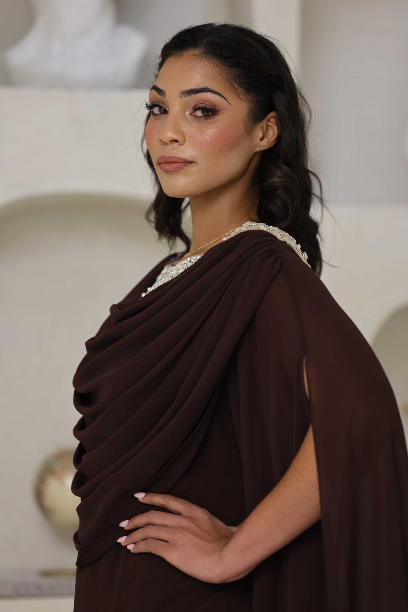 Full-length chocolate brown dress with rhinestone detailing on the neckline.