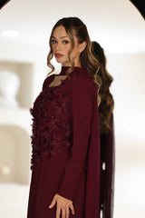 Burgundy dress with floral hand-beaded appliqué detailing.