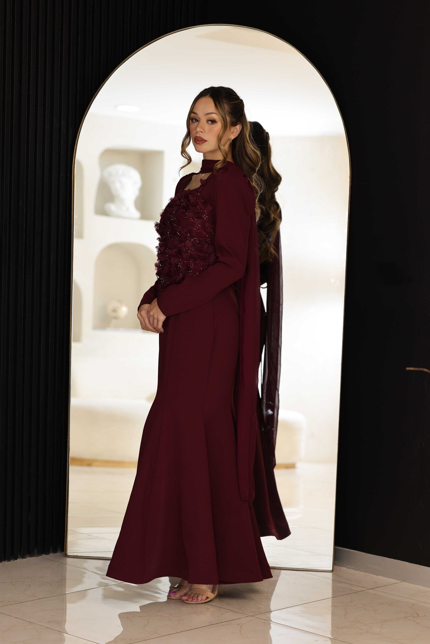 Burgundy dress with floral hand-beaded appliqué detailing.