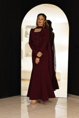 Burgundy dress with floral hand-beaded appliqué detailing.