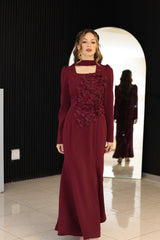 Burgundy dress with floral hand-beaded appliqué detailing.