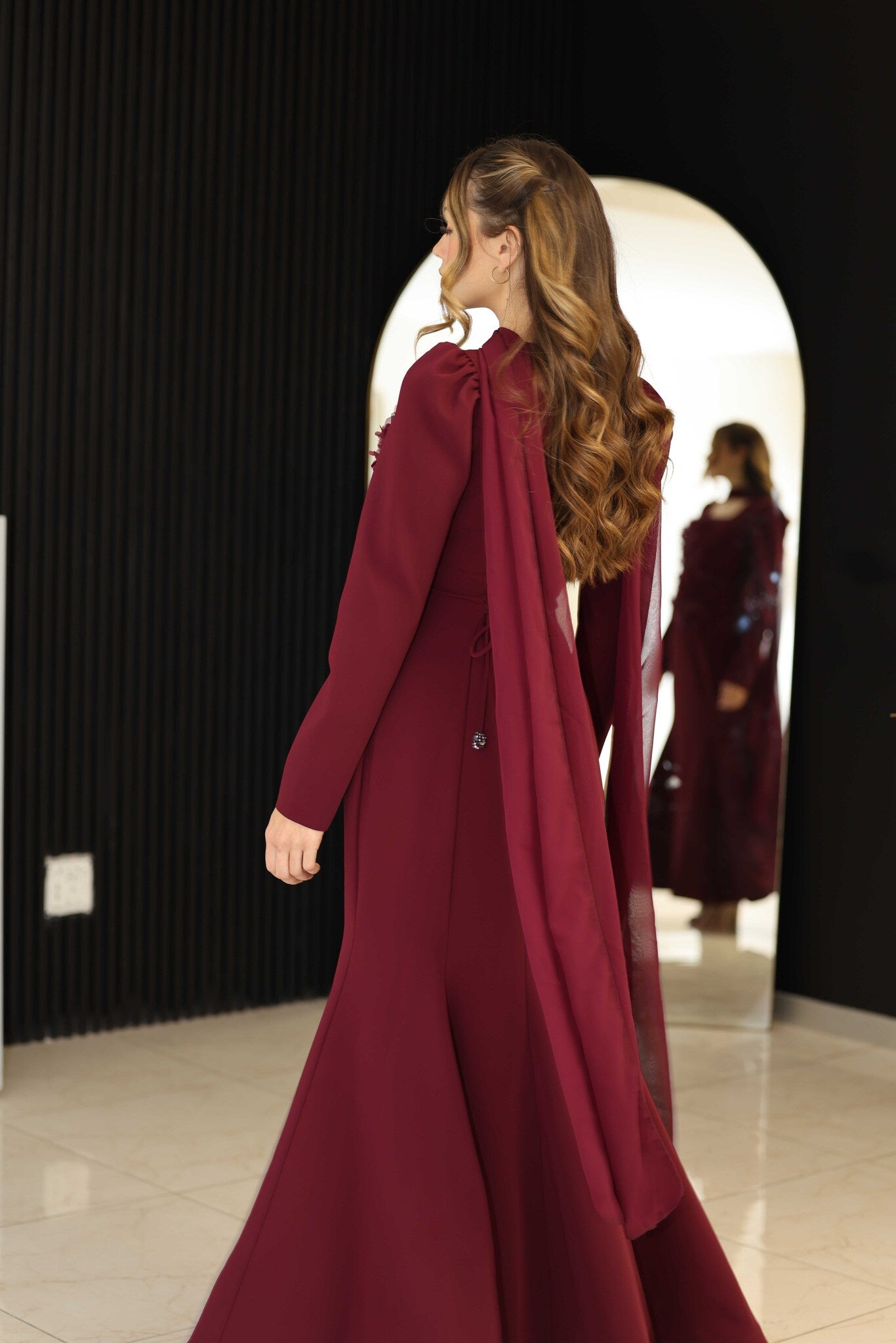 Burgundy dress with floral hand-beaded appliqué detailing.