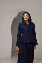 Navy blue pleated midi dress with floral appliqué and beaded detailing on the bodice.