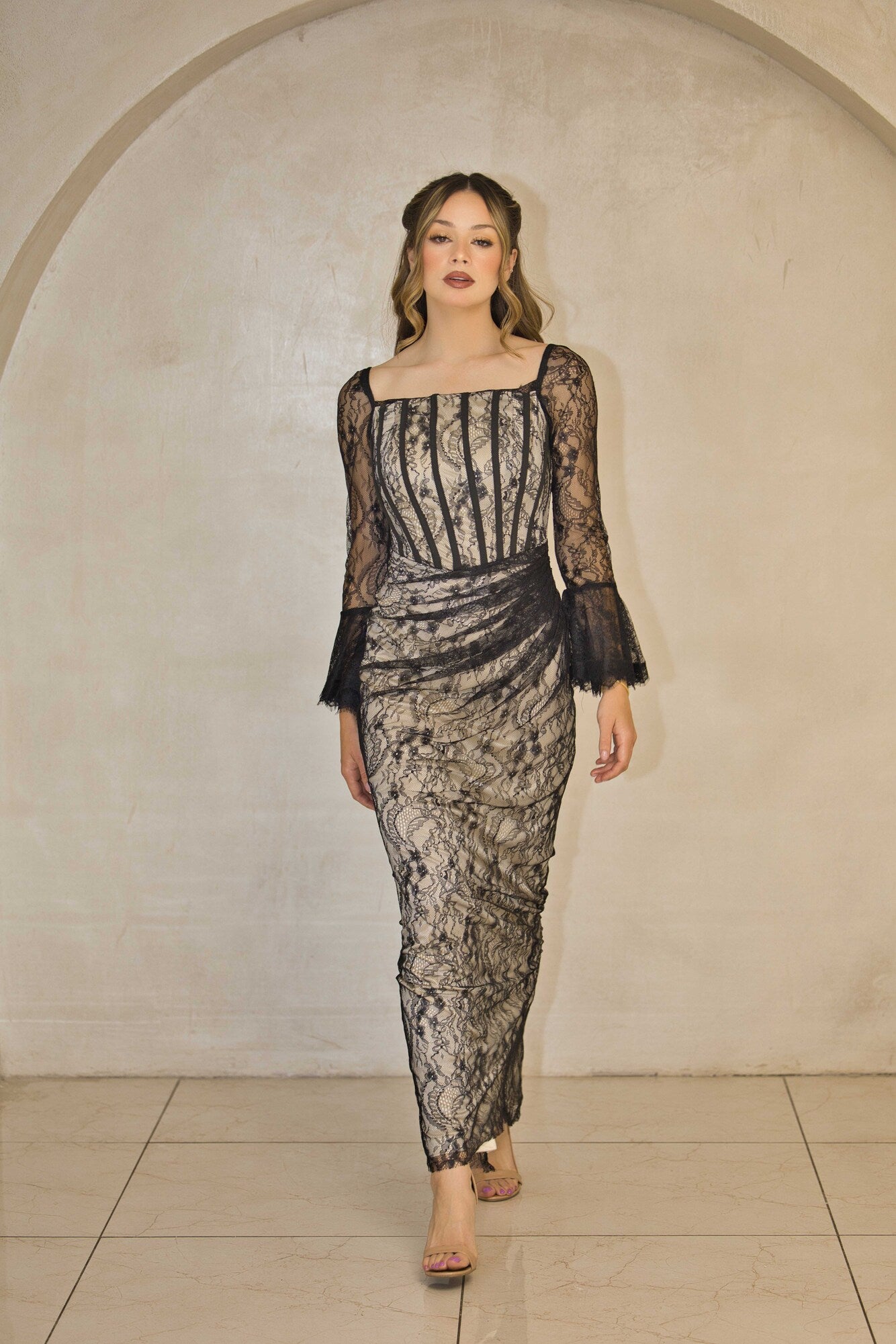 Black and nude lace maxi dress with full-length lace detailing.