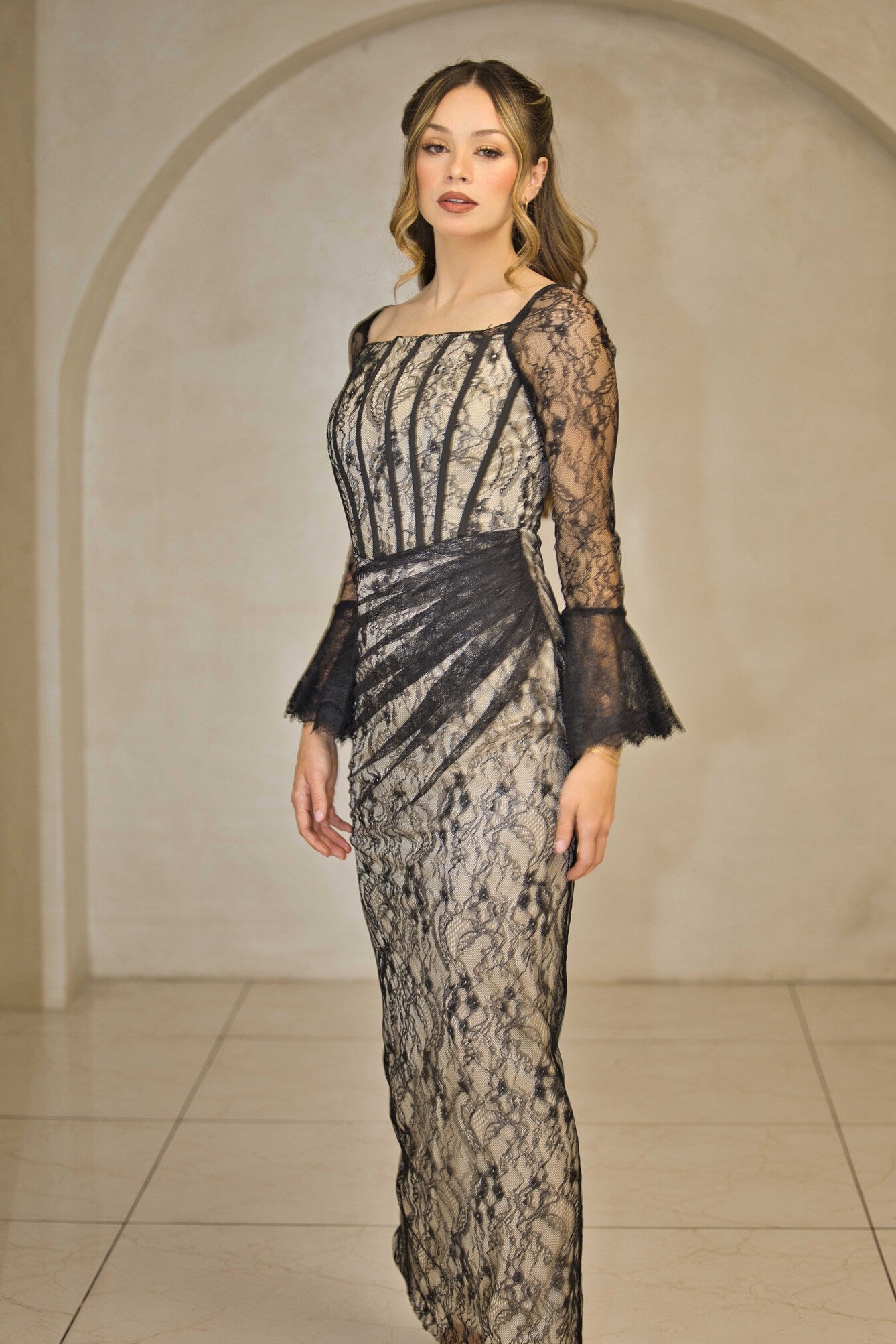 Black and nude lace maxi dress with full-length lace detailing.