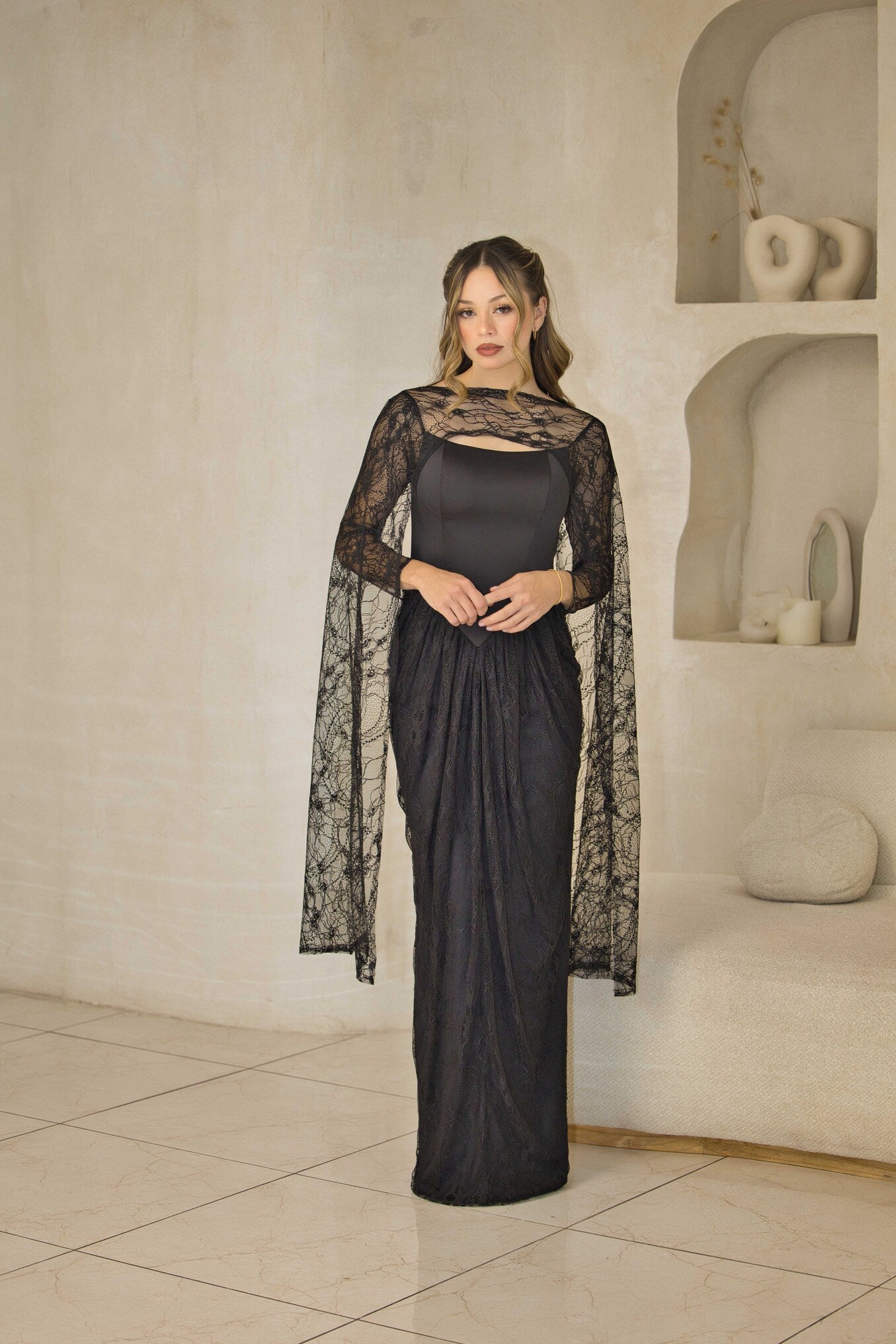 Lace evening dress with fitted corset bodice and cape sleeves.