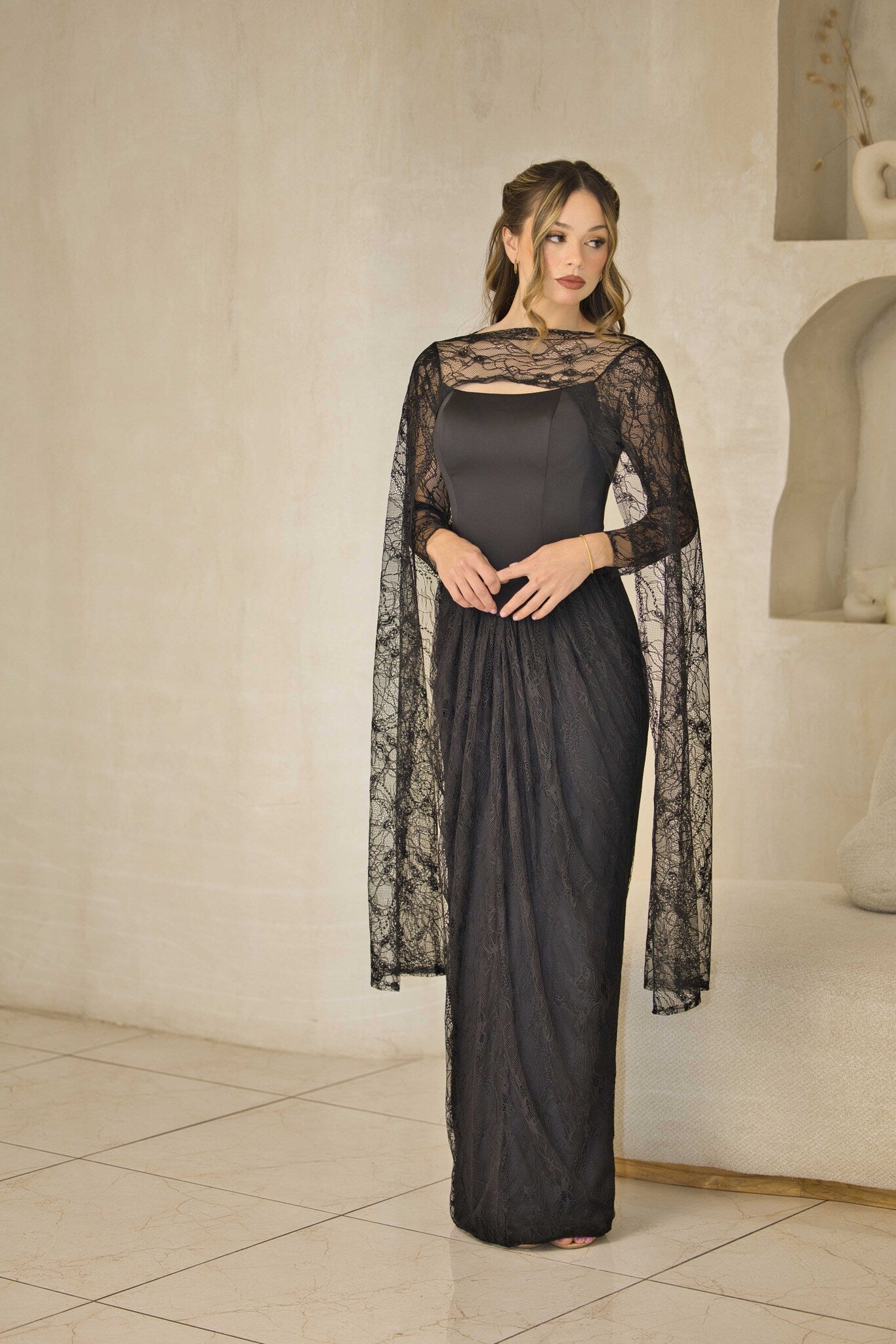Lace evening dress with fitted corset bodice and cape sleeves.
