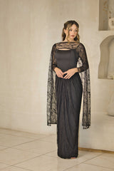 Lace evening dress with fitted corset bodice and cape sleeves.