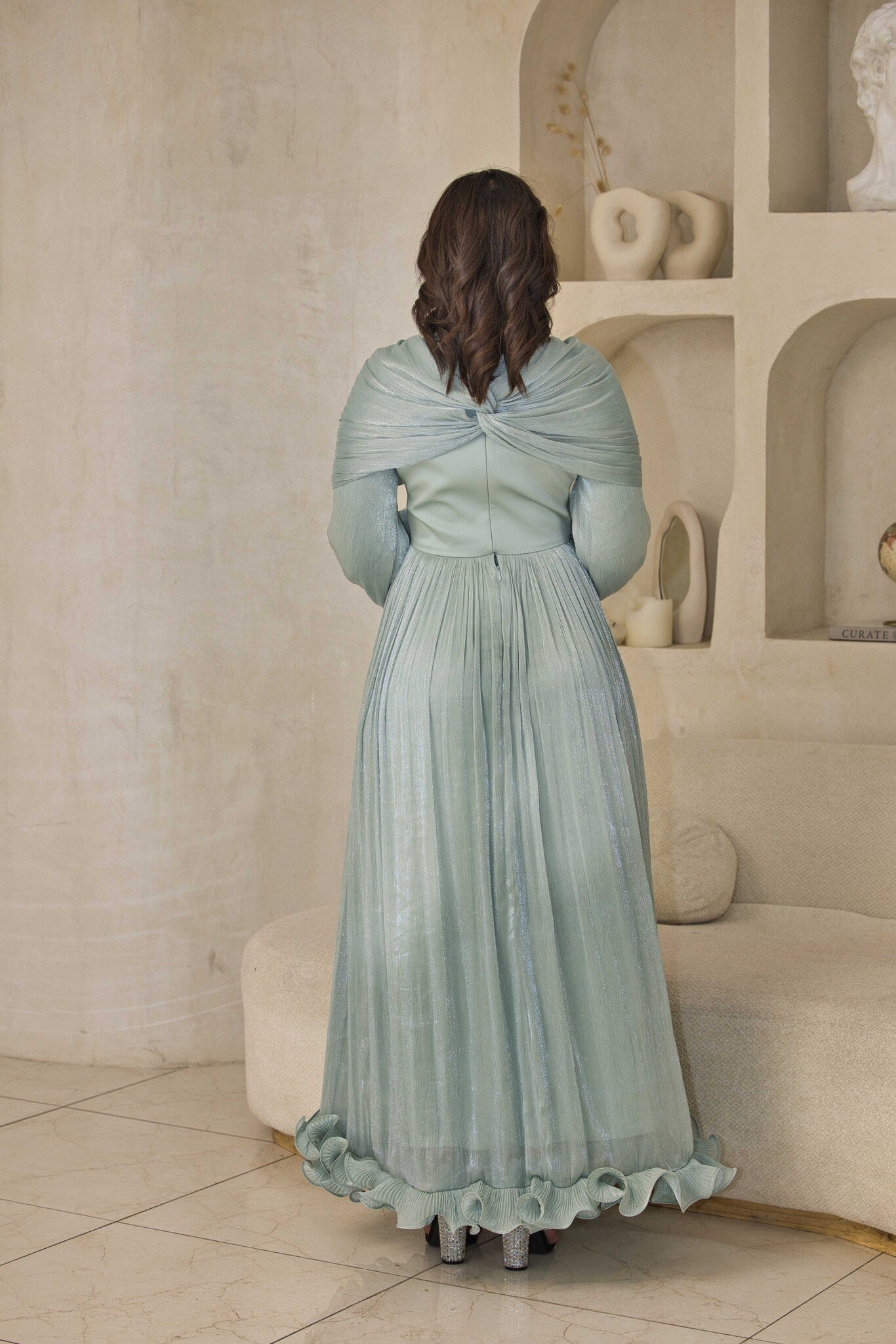 Mint green chiffon pleated dress with rhinestone detailing.