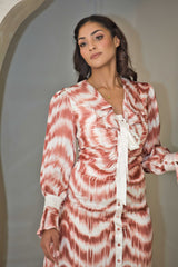 Cinnamon and white printed satin dress with a fluid silhouette.