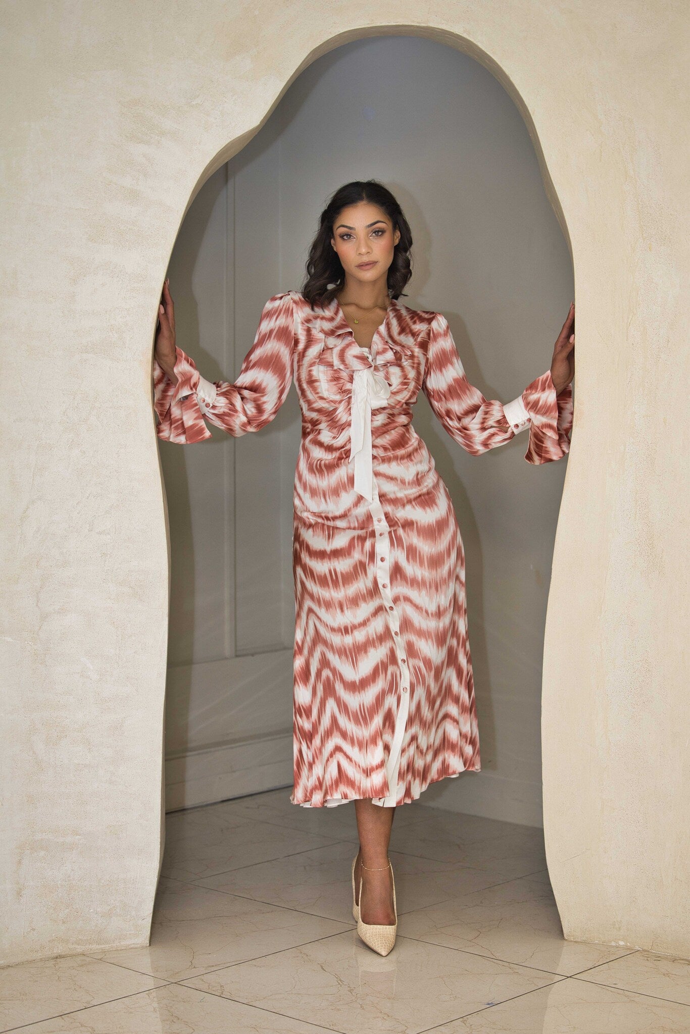 Cinnamon and white printed satin dress with a fluid silhouette.