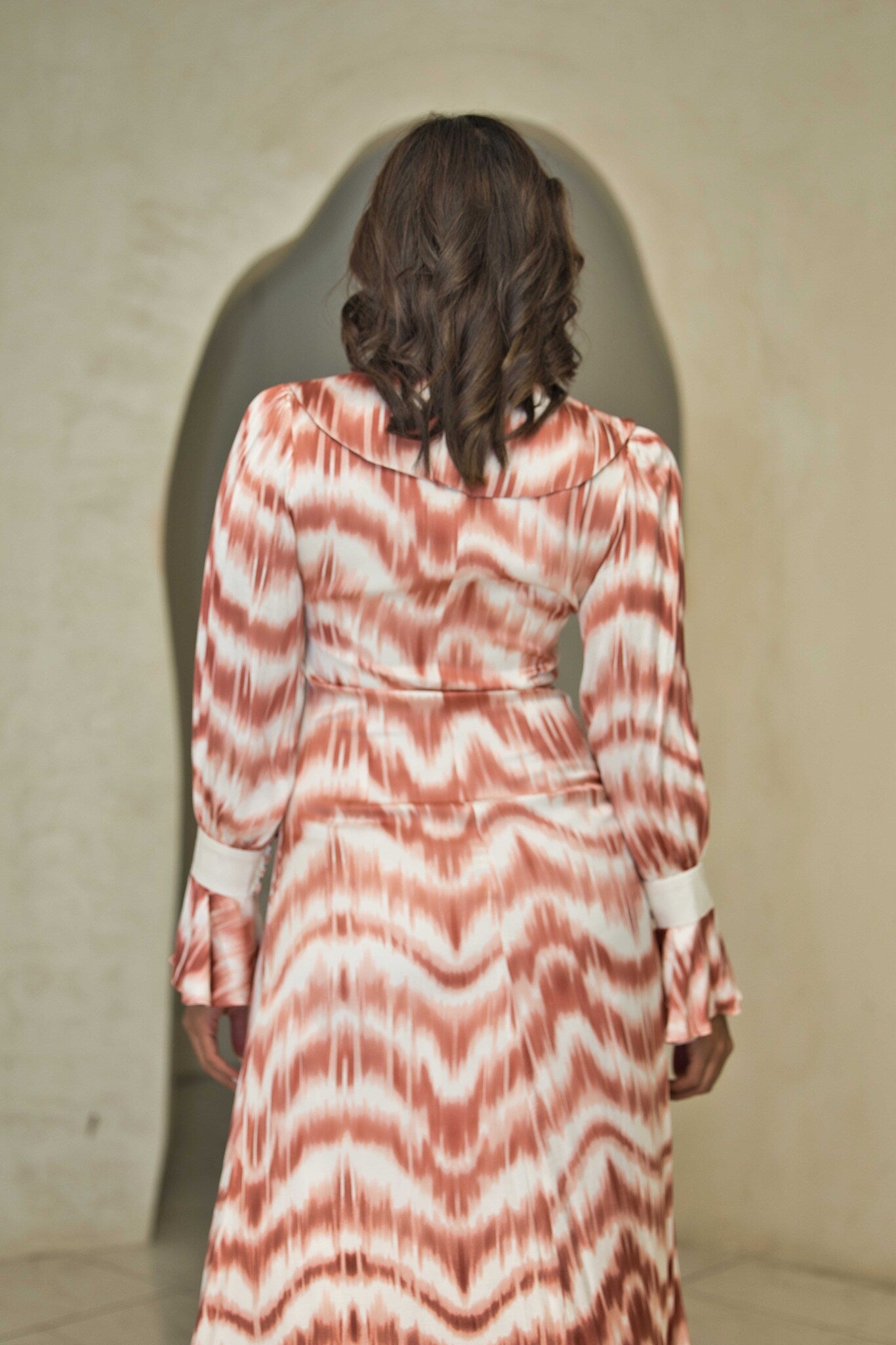 Cinnamon and white printed satin dress with a fluid silhouette.