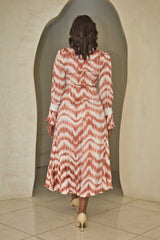 Cinnamon and white printed satin dress with a fluid silhouette.