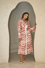 Cinnamon and white printed satin dress with a fluid silhouette.