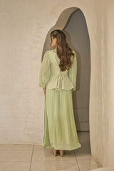 Pistachio green pleated dress with floral appliqué and hand-beaded detailing on the bodice.
