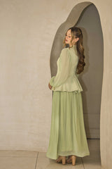 Pistachio green pleated dress with floral appliqué and hand-beaded detailing on the bodice.