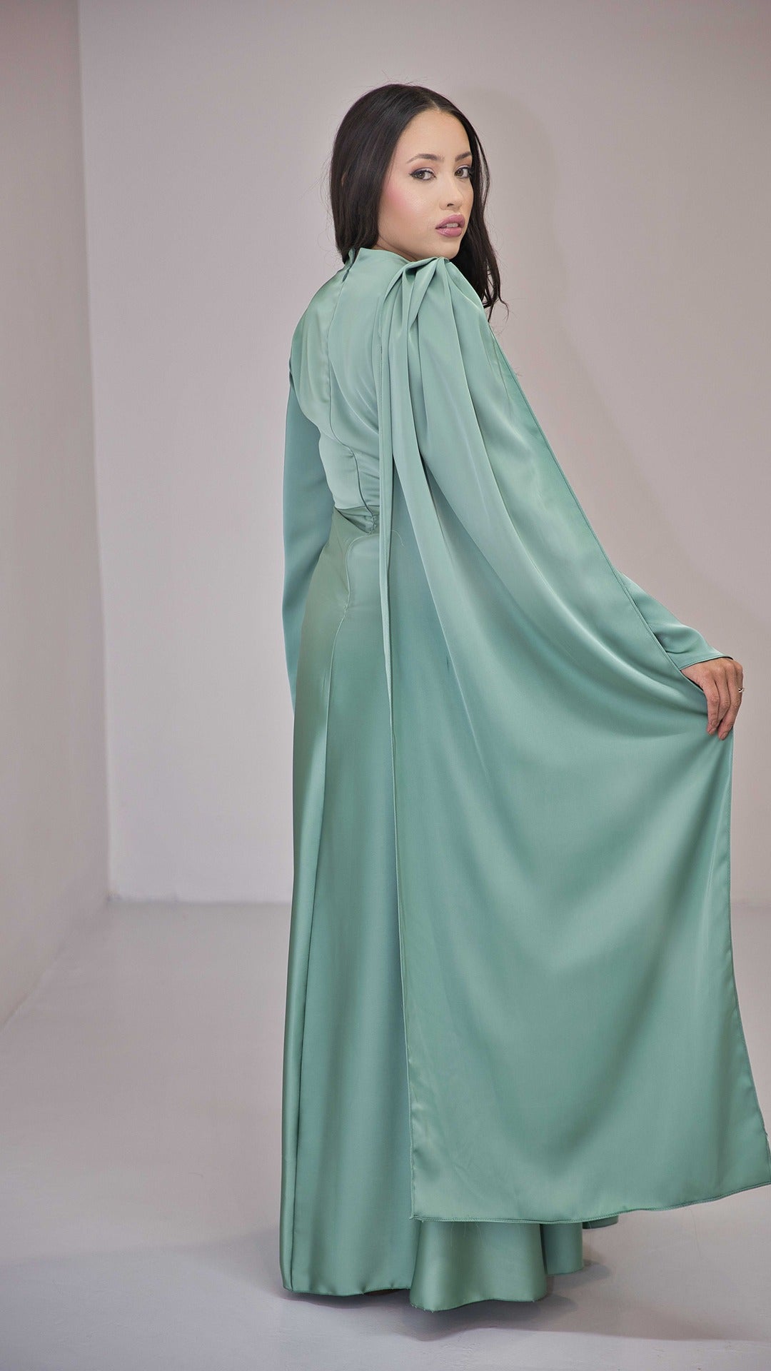 Sage Green Silk Satin Dress with Gold Embellishment and a Single Sided Cape Sleeve.